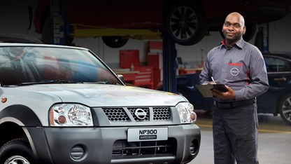 Service representative standing with a clipboard at a pickup